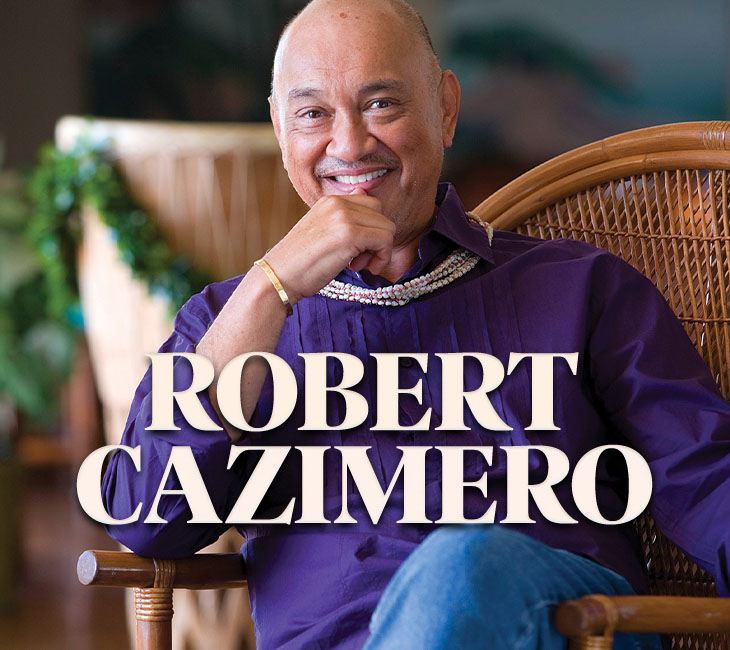 A man in a purple shirt sits on a wicker chair, smiling with his hand resting on his chin. The text "Robert Cazimero" is overlaid on the image.