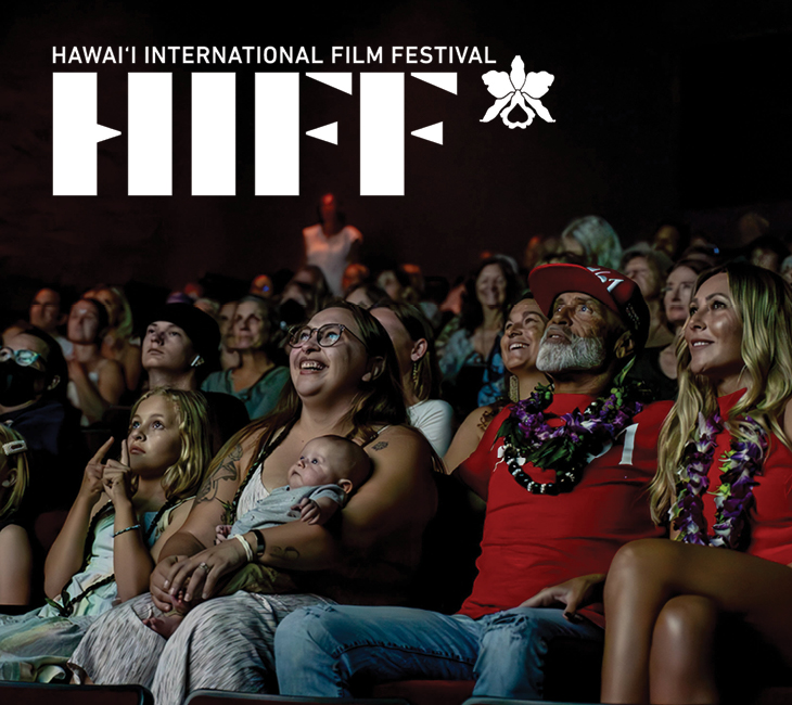 A diverse audience, including children and adults, watches a film at the Hawai'i International Film Festival, with the event logo displayed above.