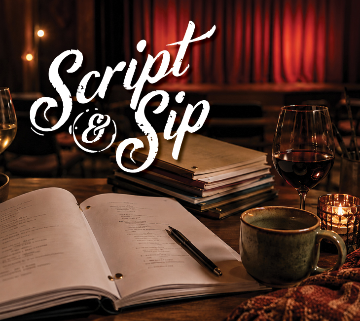 A table with scripts, a pen, a mug, a wine glass, and candles in front of a stage with the words “Script & Sip” displayed.