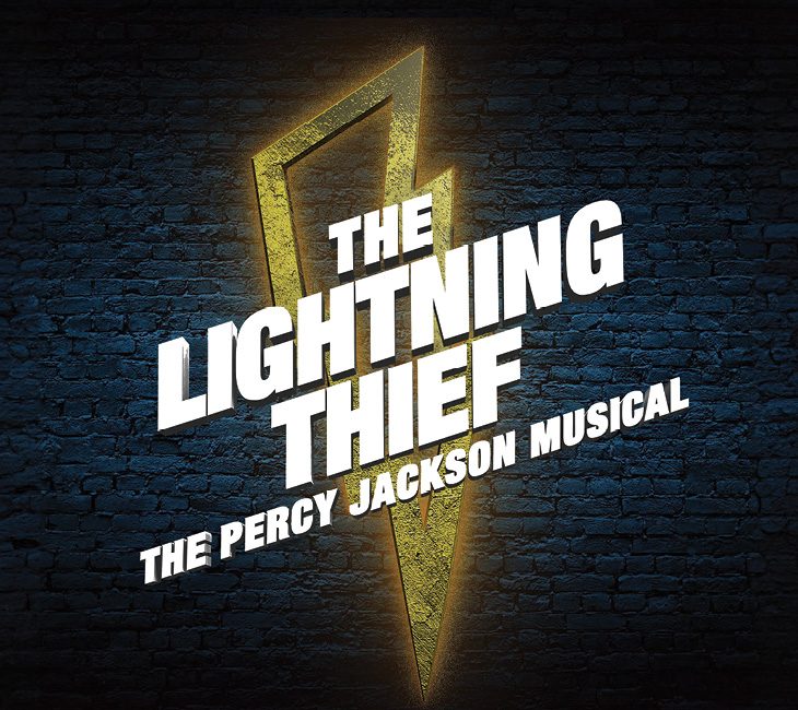 Logo for "The Lightning Thief: The Percy Jackson Musical" with bold white text over a yellow lightning bolt on a dark brick background.