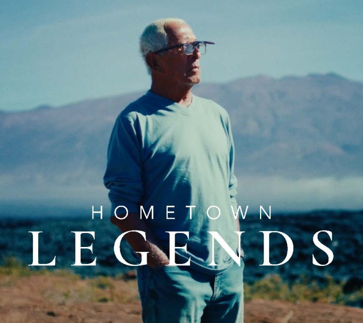 A man standing in front of a mountain with the words hometown legends.