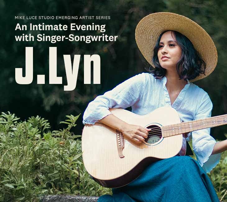 A woman sits outdoors playing a guitar, wearing a straw hat and a white blouse with text overlay promoting an event with singer-songwriter J. Lyn.