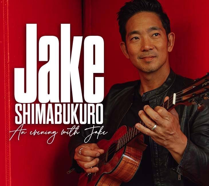 A man in a black jacket holding a ukulele is pictured against a red background. Text overlay reads "Jake Shimabukuro - An evening with Jake".